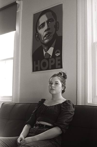Black and white interior portrait beneath a poster reading HOPE