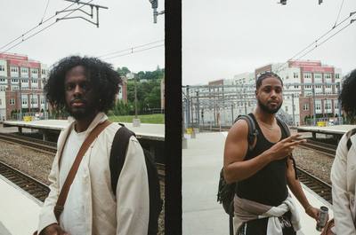 Two friends on a train platform