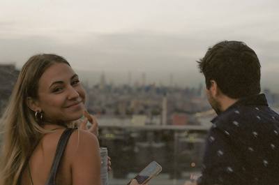 A woman looking back over her shoulder with a city skyline behind her