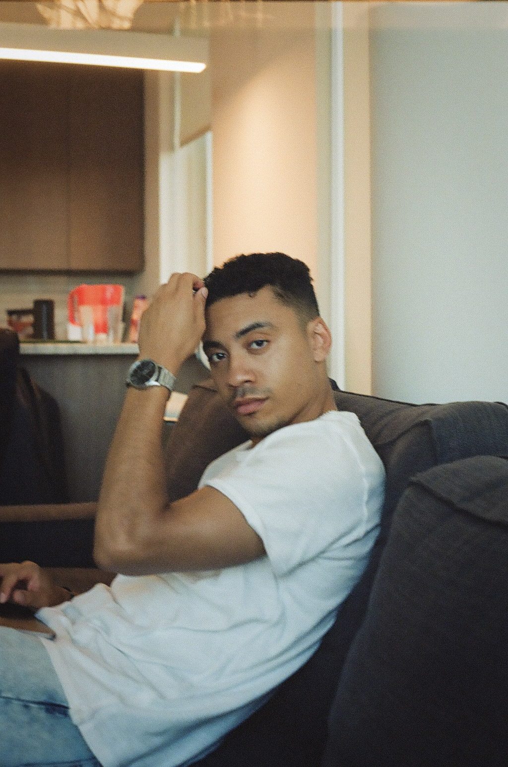 A man resting on a couch indoors