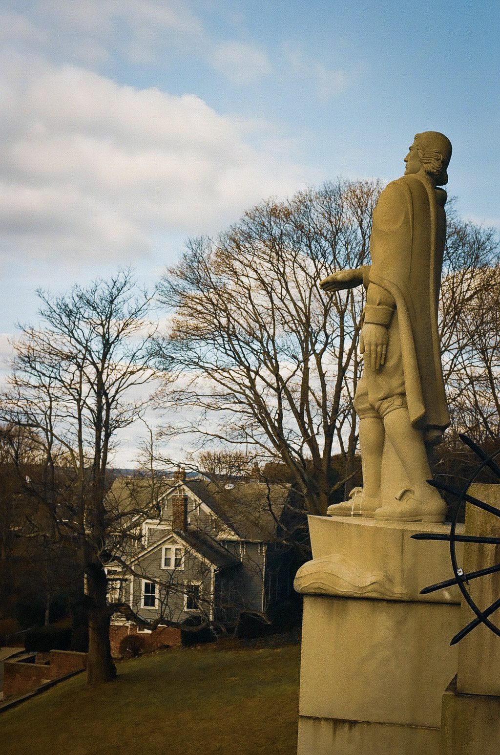 A statue on a pedestal among trees