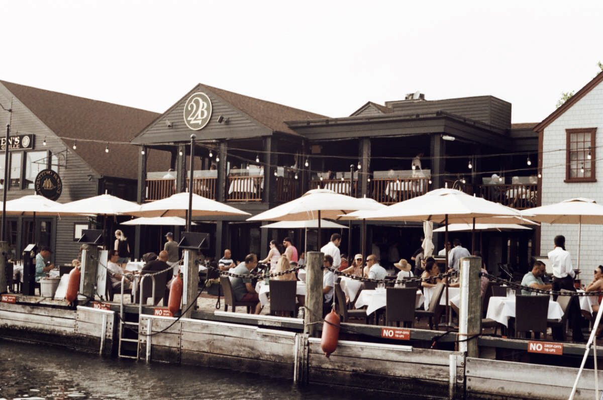 A waterfront restaurant terrace in warm evening light